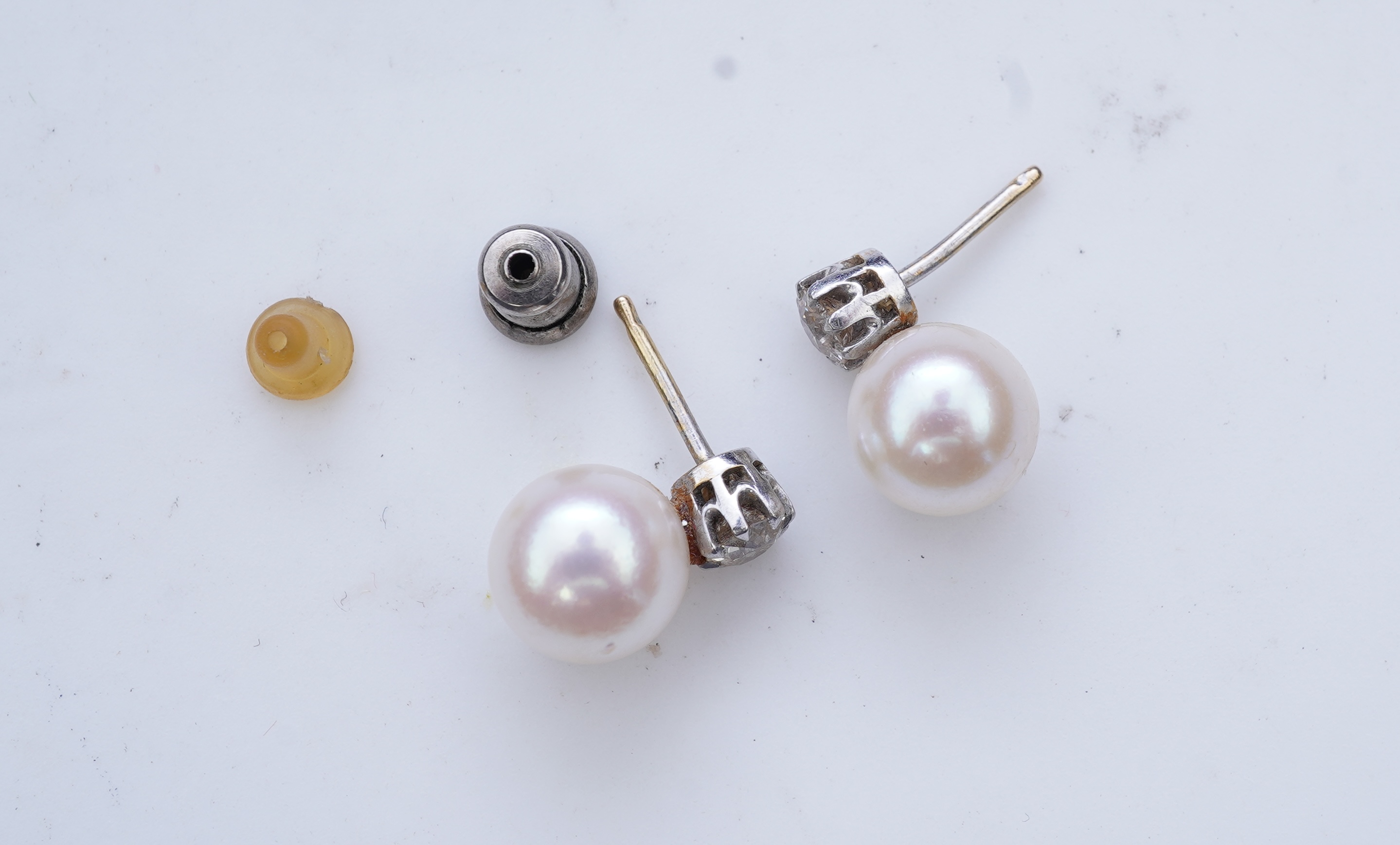 A pair of cultured pearl and diamond earrings